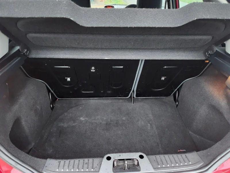 The open boot of a Burgundy Ford Fiesta viewed from the back
