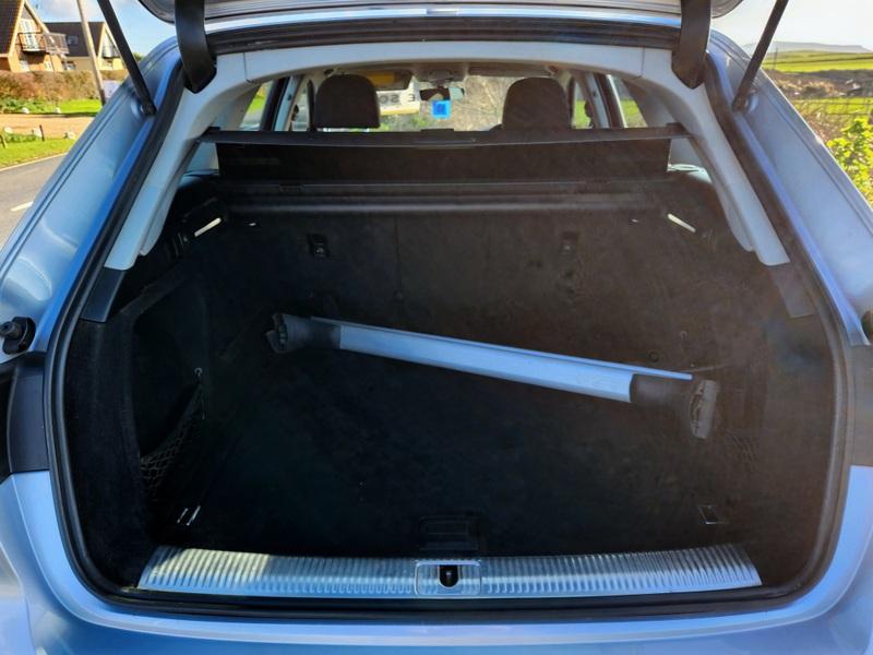 The open boot of a silver Audi A4 Sport viewed from the back