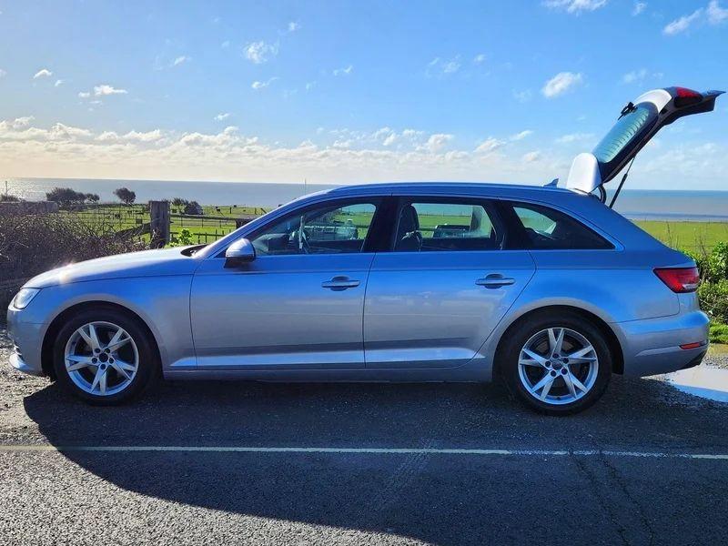 A silver Audi A4 Sport viewed from the passenger side