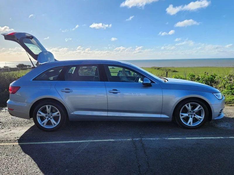 A silver Audi A4 Sport viewed from the driver side