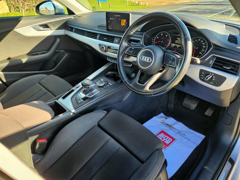 The steering controls of a silver Audi A4 Sport viewed from above the driver seat