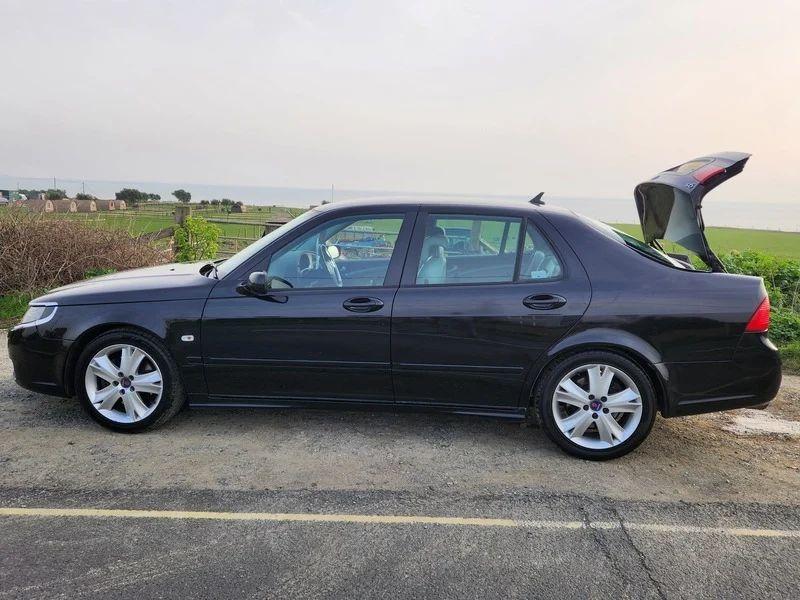 A black Saab 9-5 viewed from the passenger side