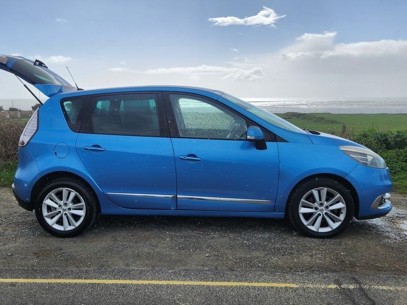 A blue Renault Scenic viewed from the driver side