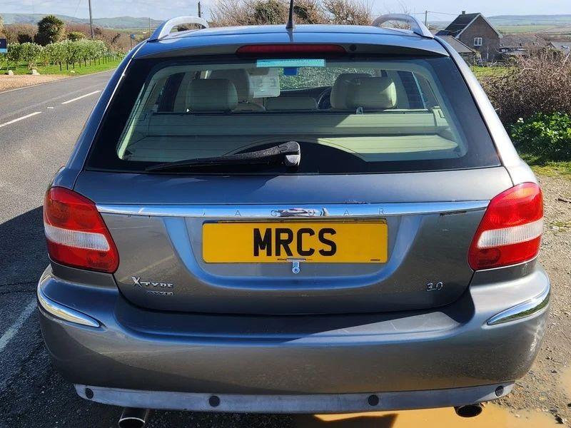 A grey Jaguar X viewed from the back