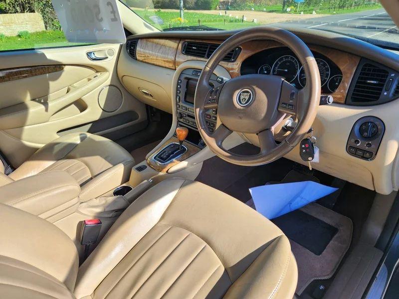 The steering controls of a grey Jaguar X viewed from above the driver seat