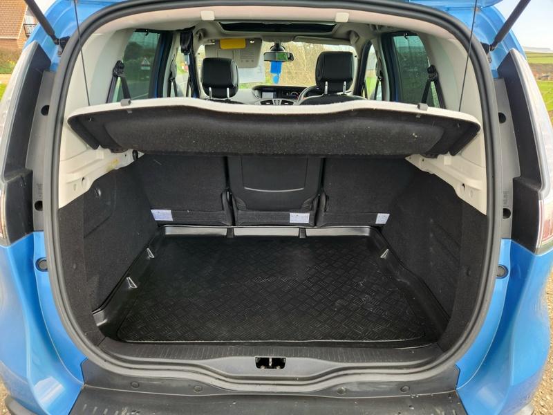 The open boot of a blue Renault Scenic viewed from the back