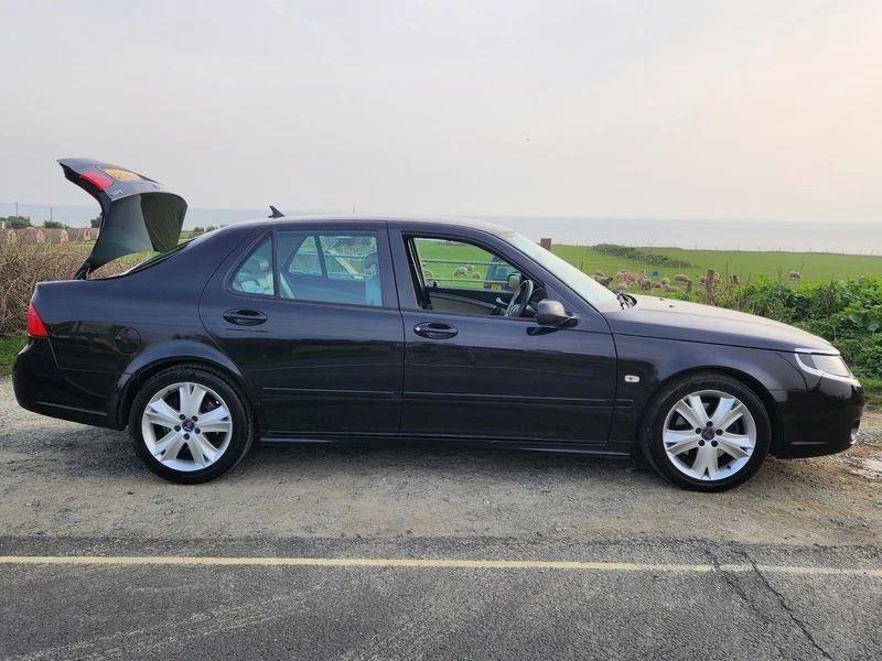 A black Saab 9-5 viewed from the driver side