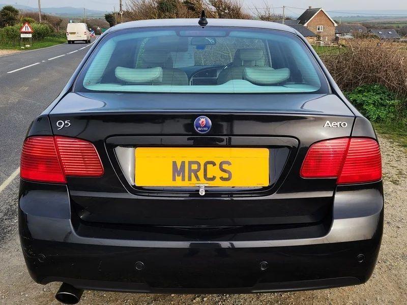 A black Saab 9-5 viewed from the back