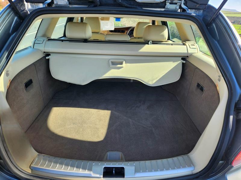 The open boot of a grey Jaguar X viewed from the back
