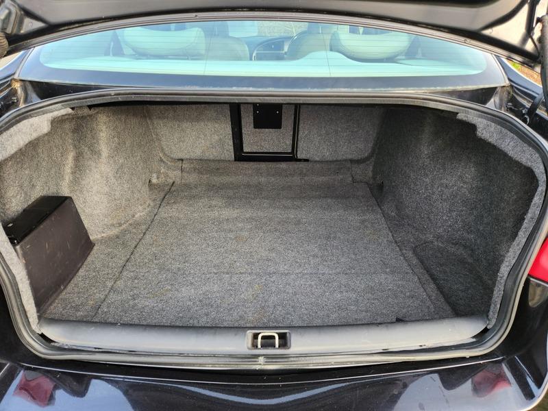 The open boot of a black Saab 9-5 viewed from the back