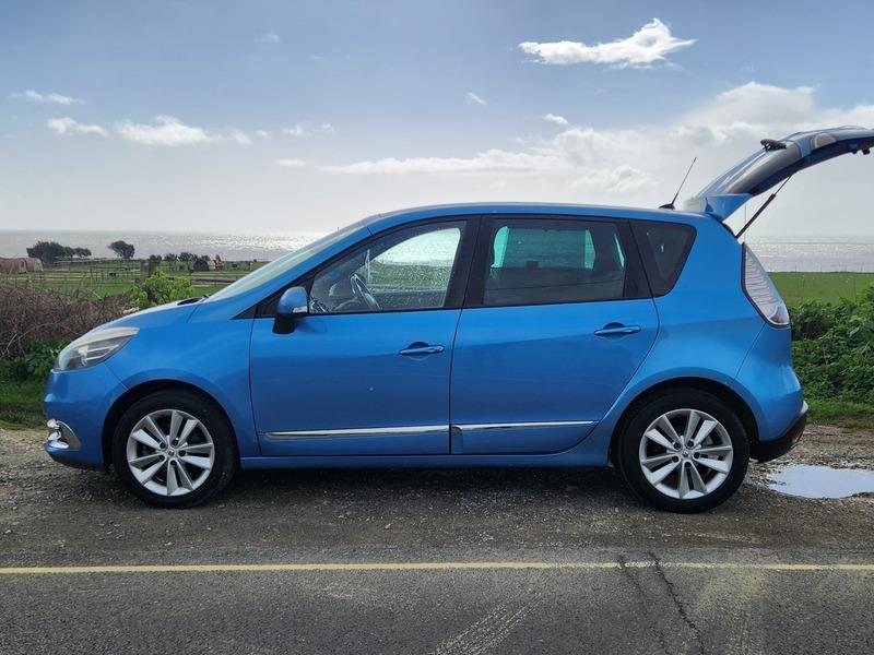 A blue Renault Scenic viewed from the passenger side