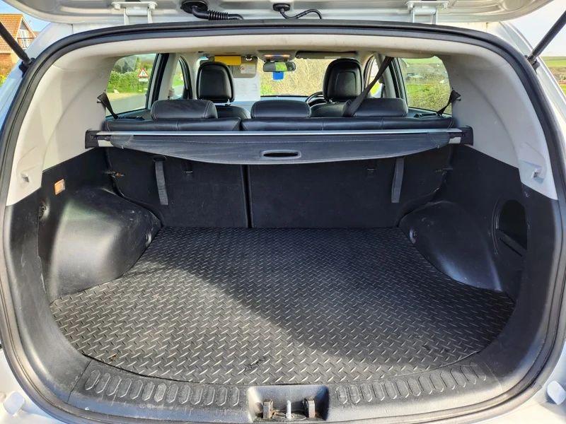 The open boot of a silver Kia Sportage 2 viewed from the back