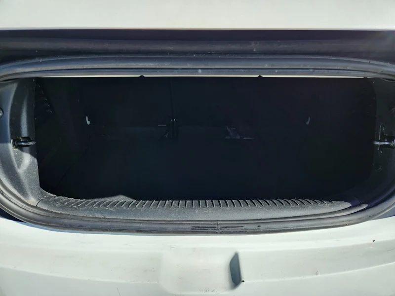 The open boot of a white Citroen DS3 Convertible viewed from the back
