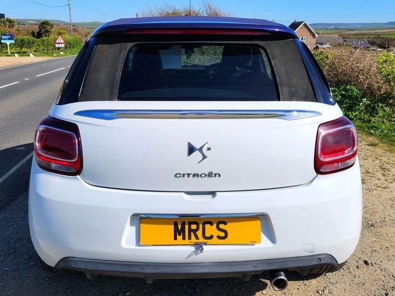 A white Citroen DS3 Convertible viewed from the back