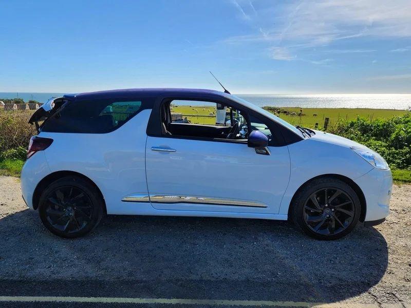 A white Citroen DS3 Convertible viewed from the driver side