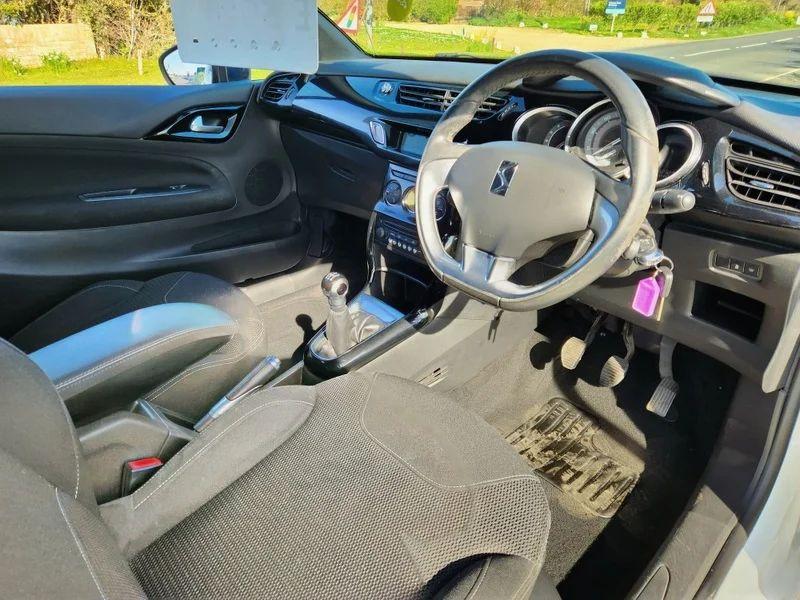 The steering controls of a white Citroen DS3 Convertible viewed from above the driver seat