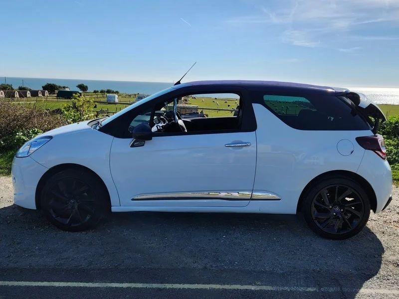 A white Citroen DS3 Convertible viewed from the passenger side