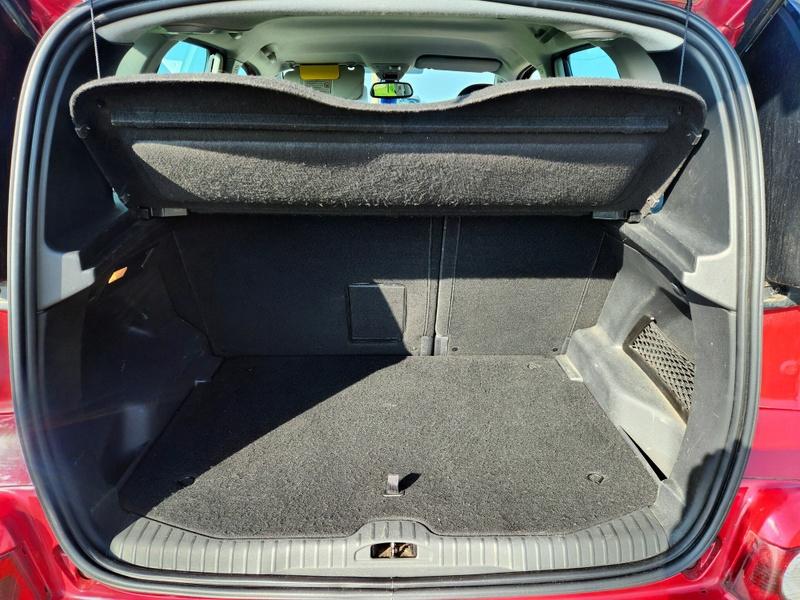 The open boot of a red Citroen Picasso viewed from the back