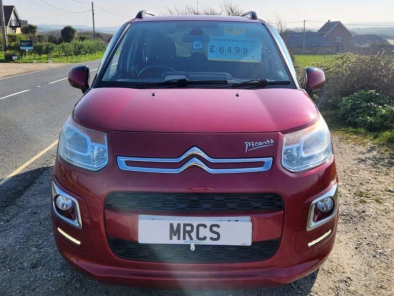 A red Citroen Picasso viewed from the front