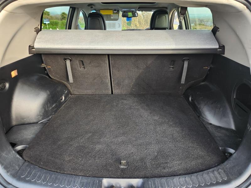 The open boot of a bronze Kia Sportage 3 viewed from the back