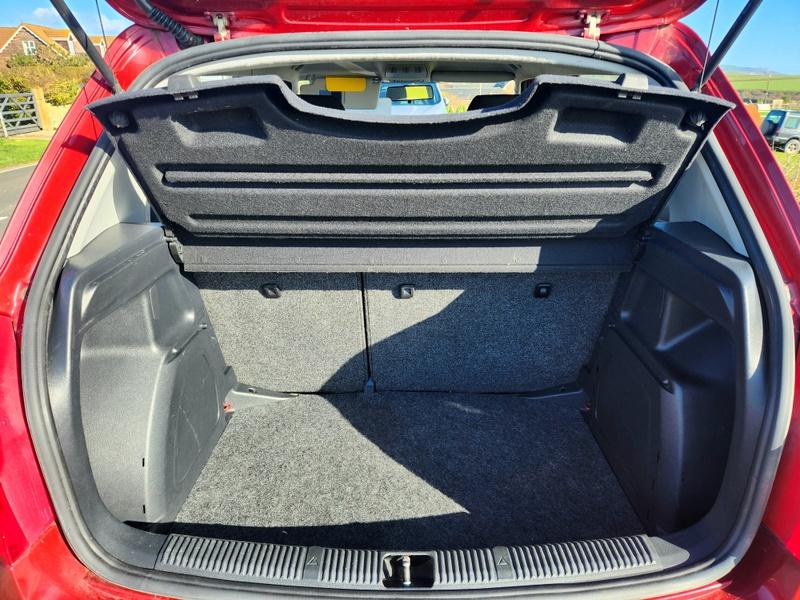 The open boot of a red Skoda Fabia HTP 1 viewed from the back
