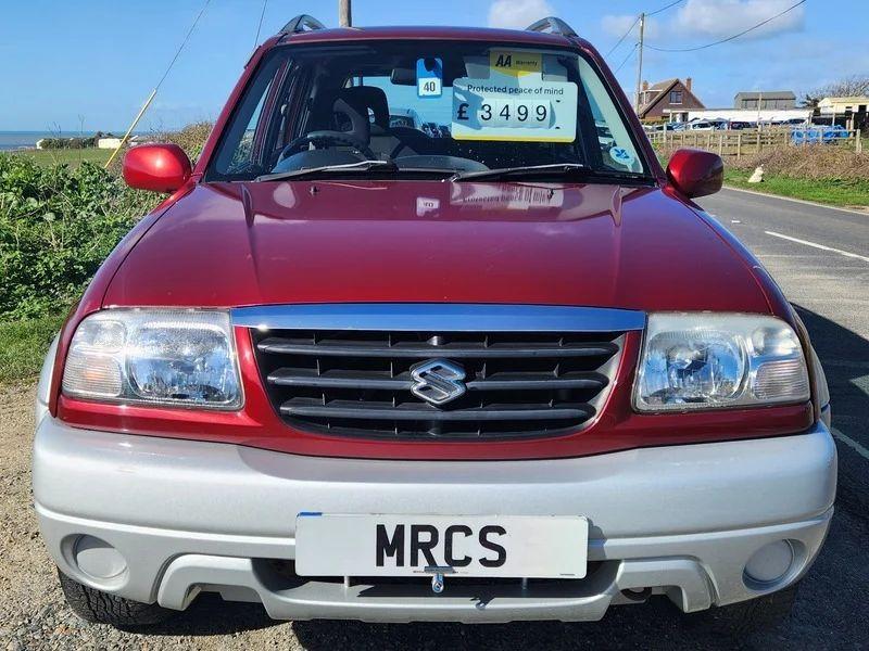 A red Suzuki Grand Vitara viewed from the front