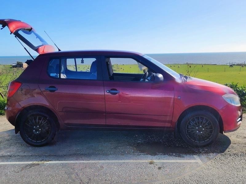 A red Skoda Fabia HTP 1 viewed from the driver side