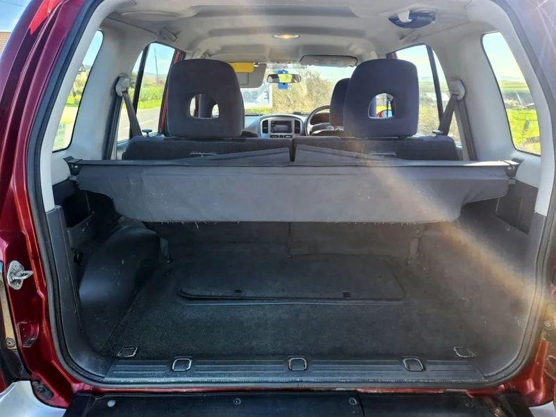 The open boot of a red Suzuki Grand Vitara viewed from the back