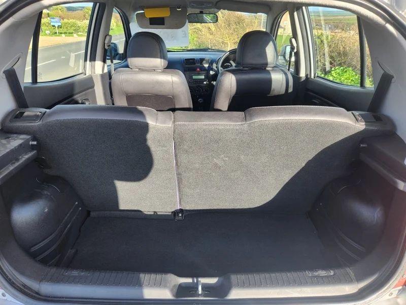 The open boot of a sparkling silver metallic Kia Picanto viewed from the back