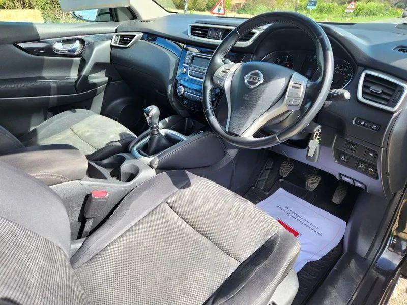 The steering controls of a Magnetic Black Nissan Qashqai viewed from above the driver seat