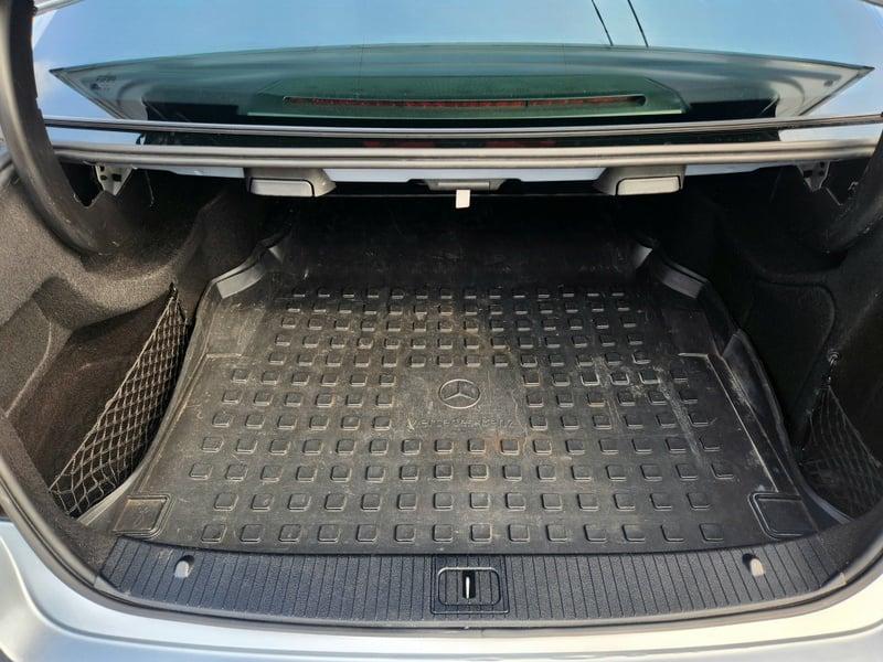 The open boot of a Iridium Silver Mercedes E-Class viewed from the back
