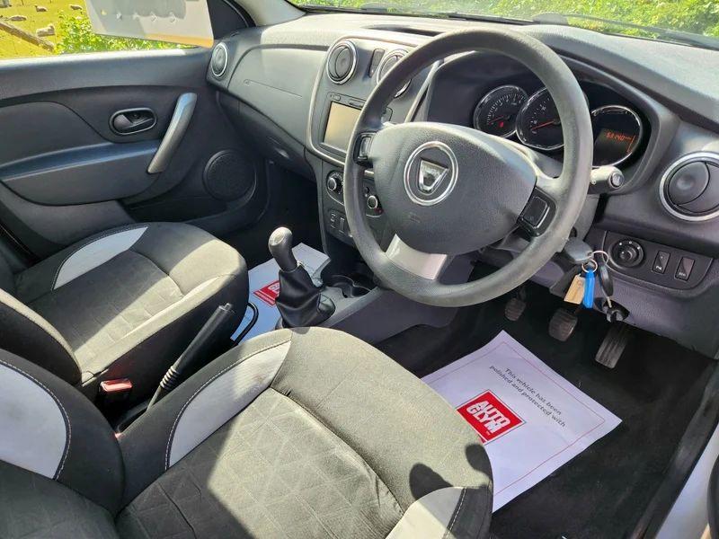 The steering controls of a Platinum Silver Metallic Dacia Sandero Stepway viewed from above the driver seat