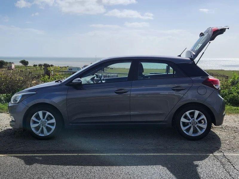 A Mystic Blue Metallic Hyundai i20 viewed from the passenger side