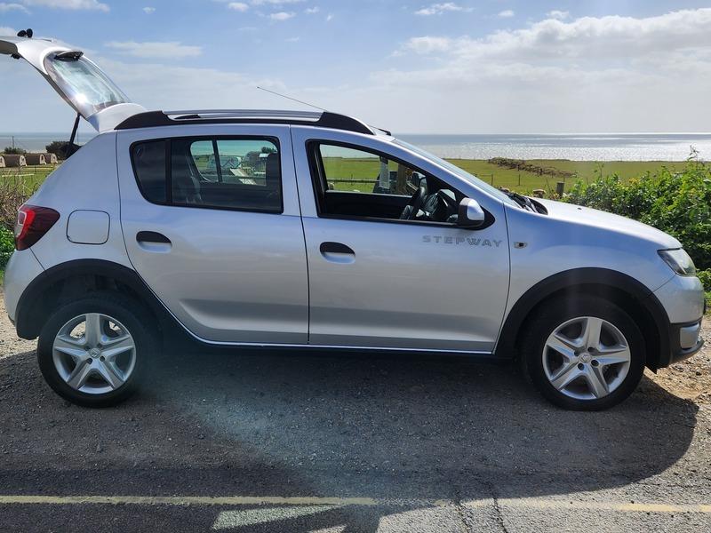 A Platinum Silver Metallic Dacia Sandero Stepway viewed from the driver side