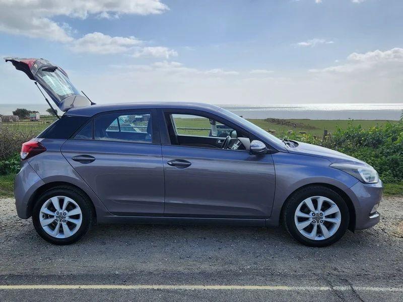 A Mystic Blue Metallic Hyundai i20 viewed from the driver side