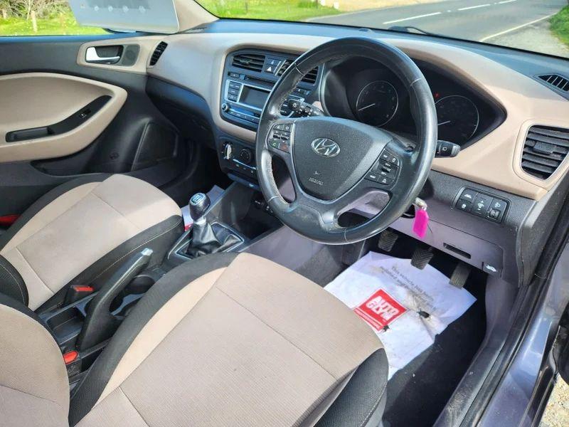 The steering controls of a Mystic Blue Metallic Hyundai i20 viewed from above the driver seat