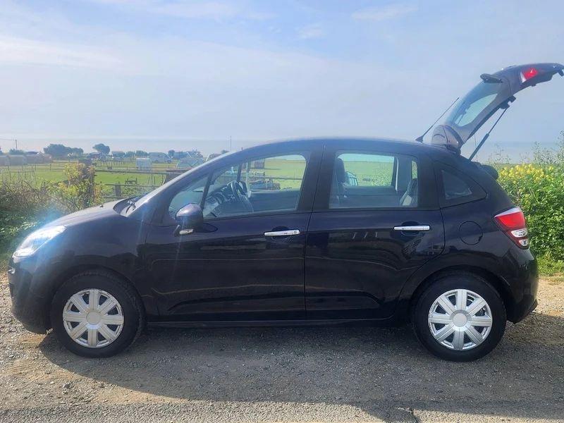 A Citroen C3 in Midnight Blue Metallic, viewed from the passenger side