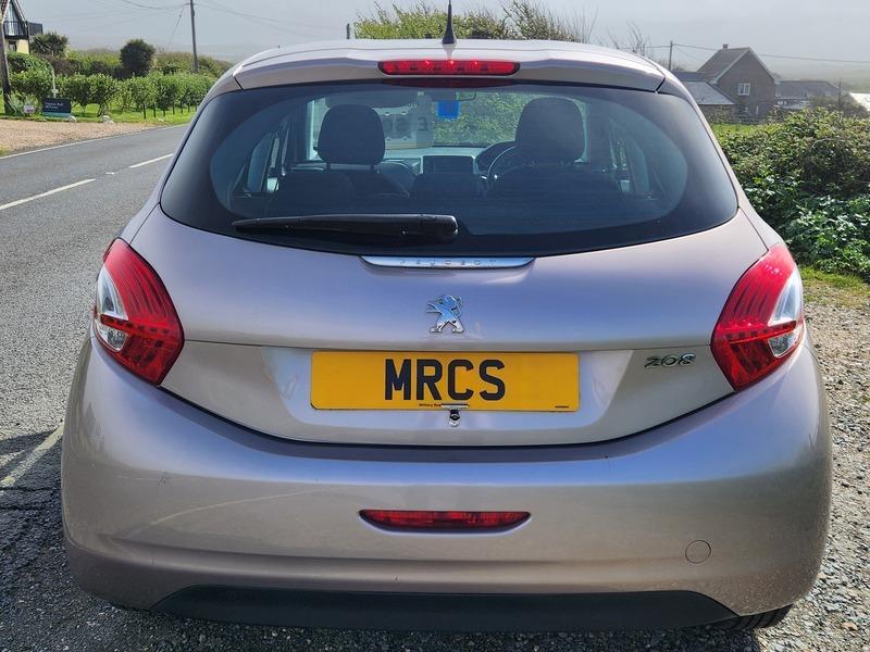 A Peugeot 208 in Rose Pink Quartz Metallic viewed from the back