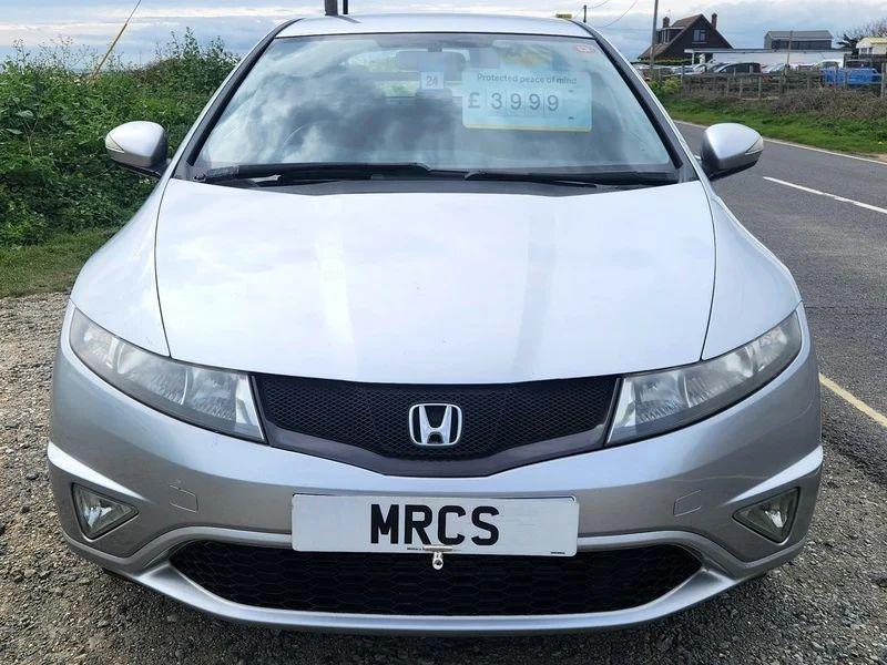 A Honda Civic Sport in Alabaster Silver Metallic viewed from the front