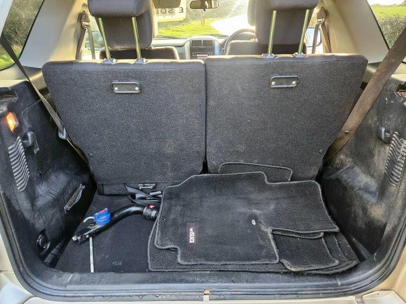 The open boot of a Suzuki Grand Vitara in Mars Gold Metallic, viewed from the back.
