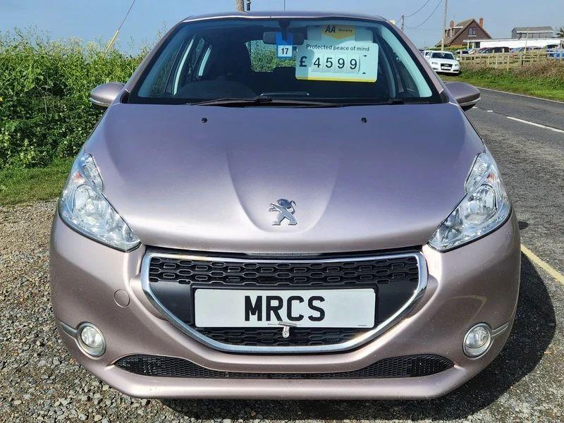 A Peugeot 208 in Rose Pink Metallic viewed from the front