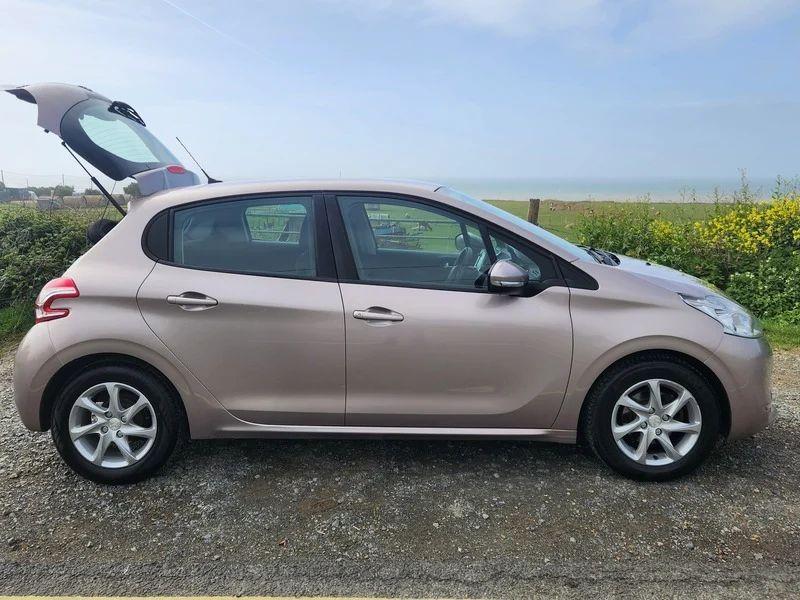 A Peugeot 208 in Rose Pink Quartz Metallic viewed from the driver side