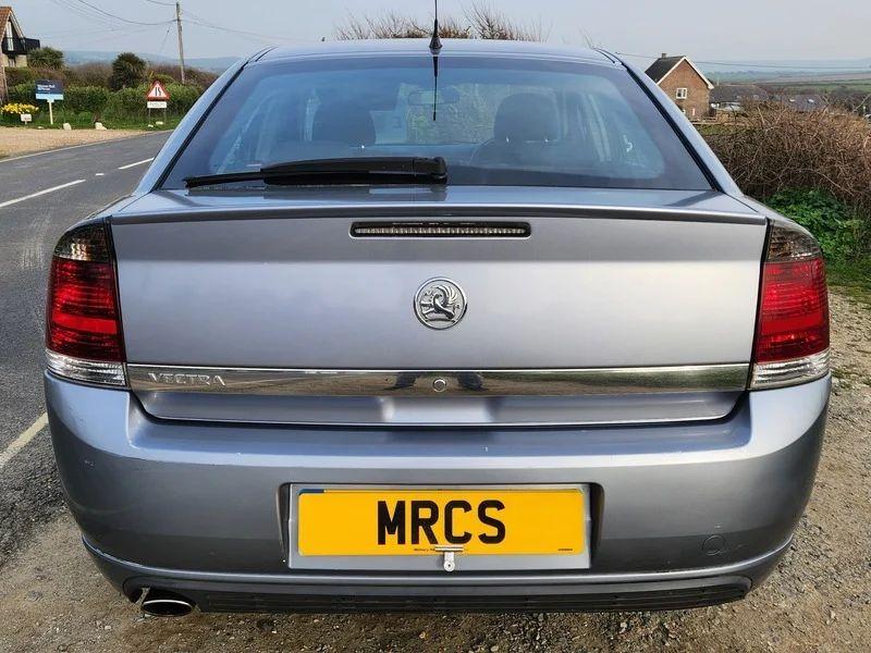A Vauxhall Vectra in Ultra Blue Metallic, viewed from the back.