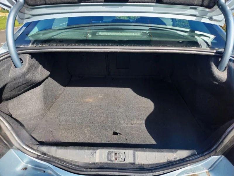 The open boot of a Peugeot 508 Allure in Twilight Blue Metallic, viewed from the back.