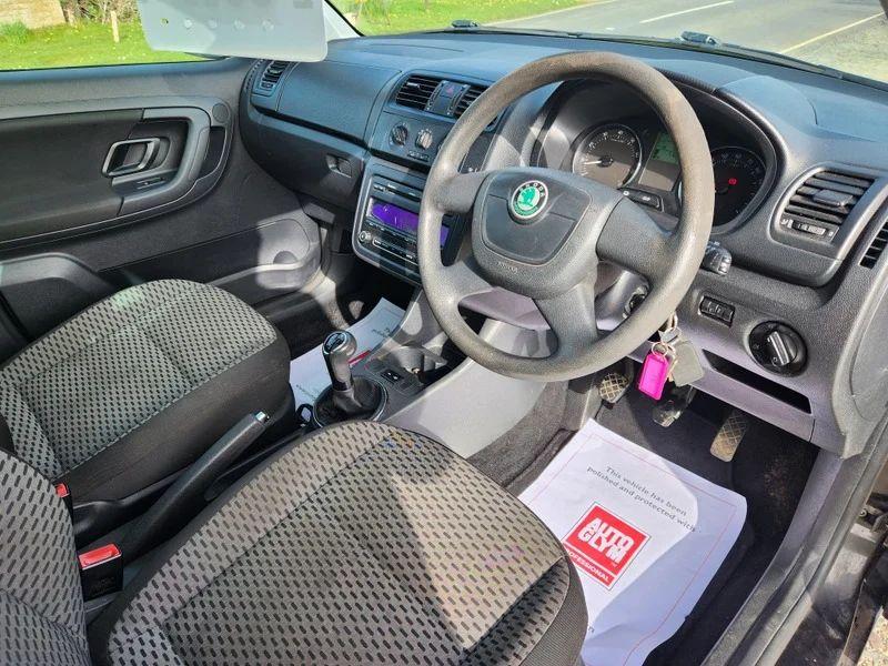 The steering controls of a Skoda Roomster in Jet Black Metallic, viewed from above the driver seat.