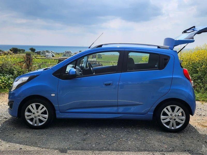 A blue Chevrolet viewed from the passenger side