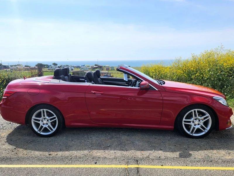 A red Mercedes viewed from the driver side