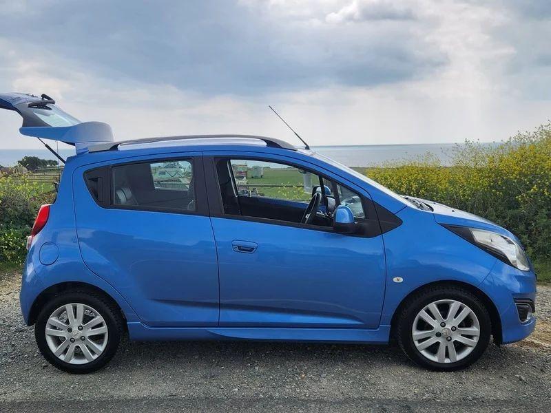 A blue Chevrolet viewed from the driver side