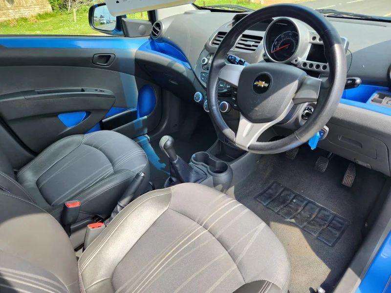 The steering controls of a blue Chevrolet viewed from above the driver seat