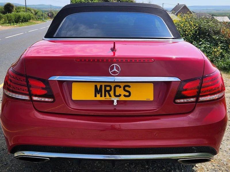 A red Mercedes viewed from the back
